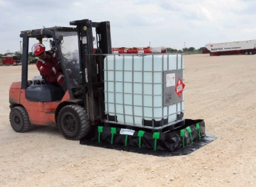 IBC tote placed inside a spill berm at a municipal yard
