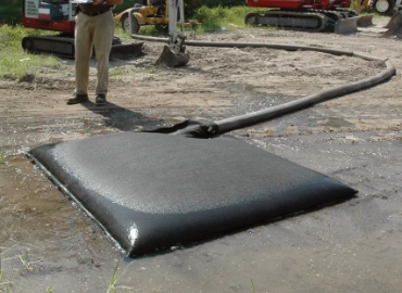 Dewatering bag capturing sediment on a municipal job site
