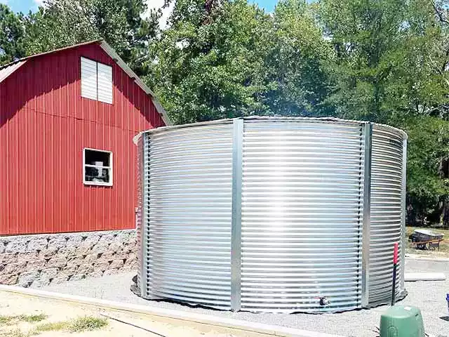 corrugated tank next to a red house