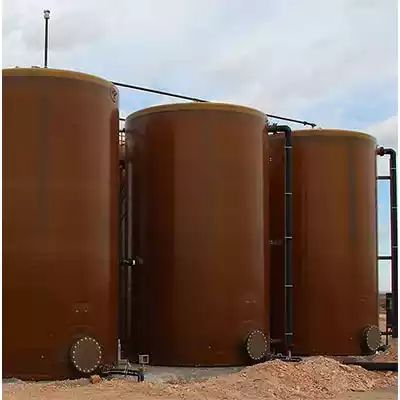 Three above ground fiberglass tanks side by side