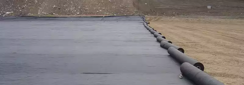 Rolls of Mirafi geotextile being rolled out across a construction site