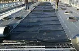 Concrete curing blankets on a construction site