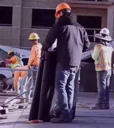 Man laying down a concrete heating blanket